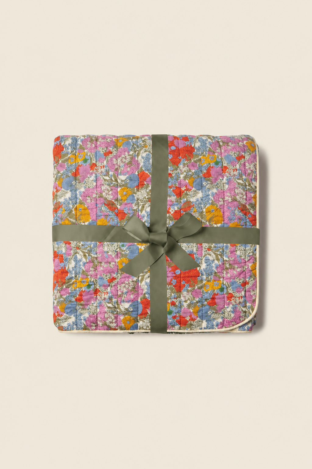 Trovata Delicate Tilia printed throw blanket — folded and tied with an olive ribbon bow